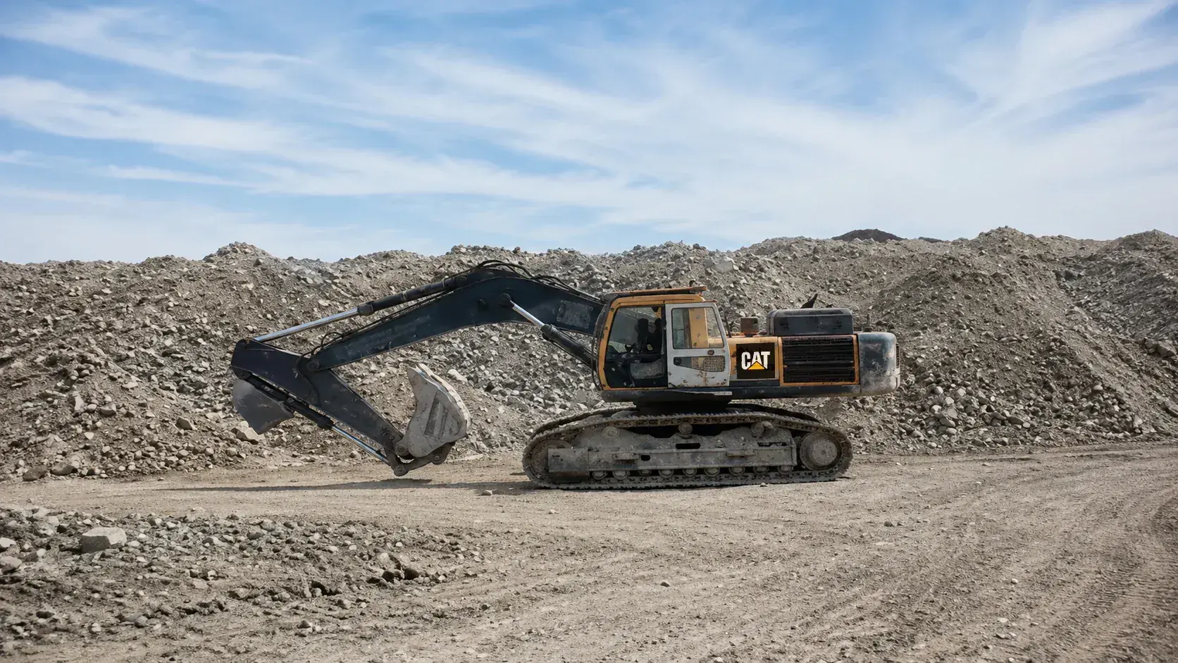 Excavator moving waste rock at the open-cast operation